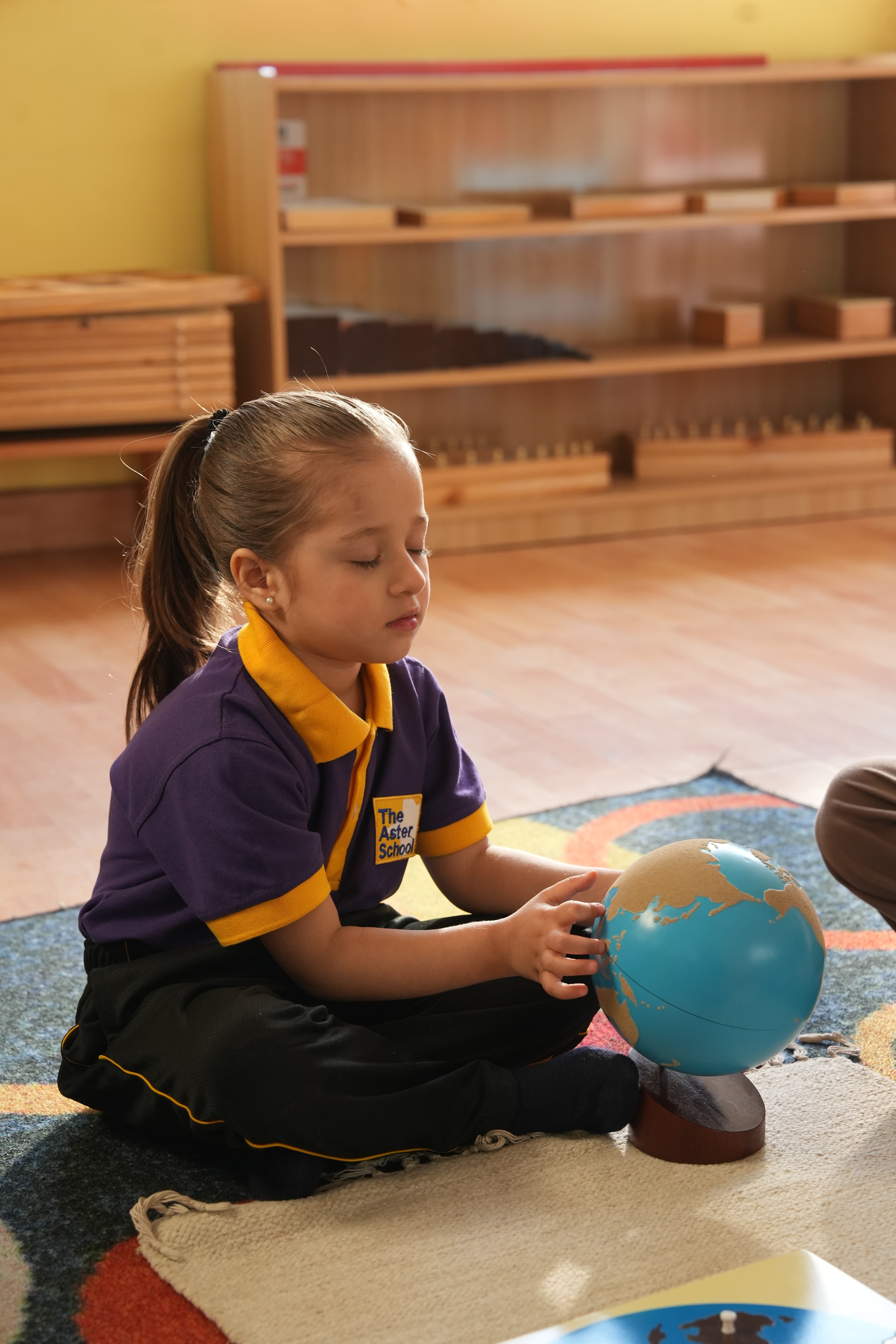 An Aster child engaged in purposeful, hands-on learning