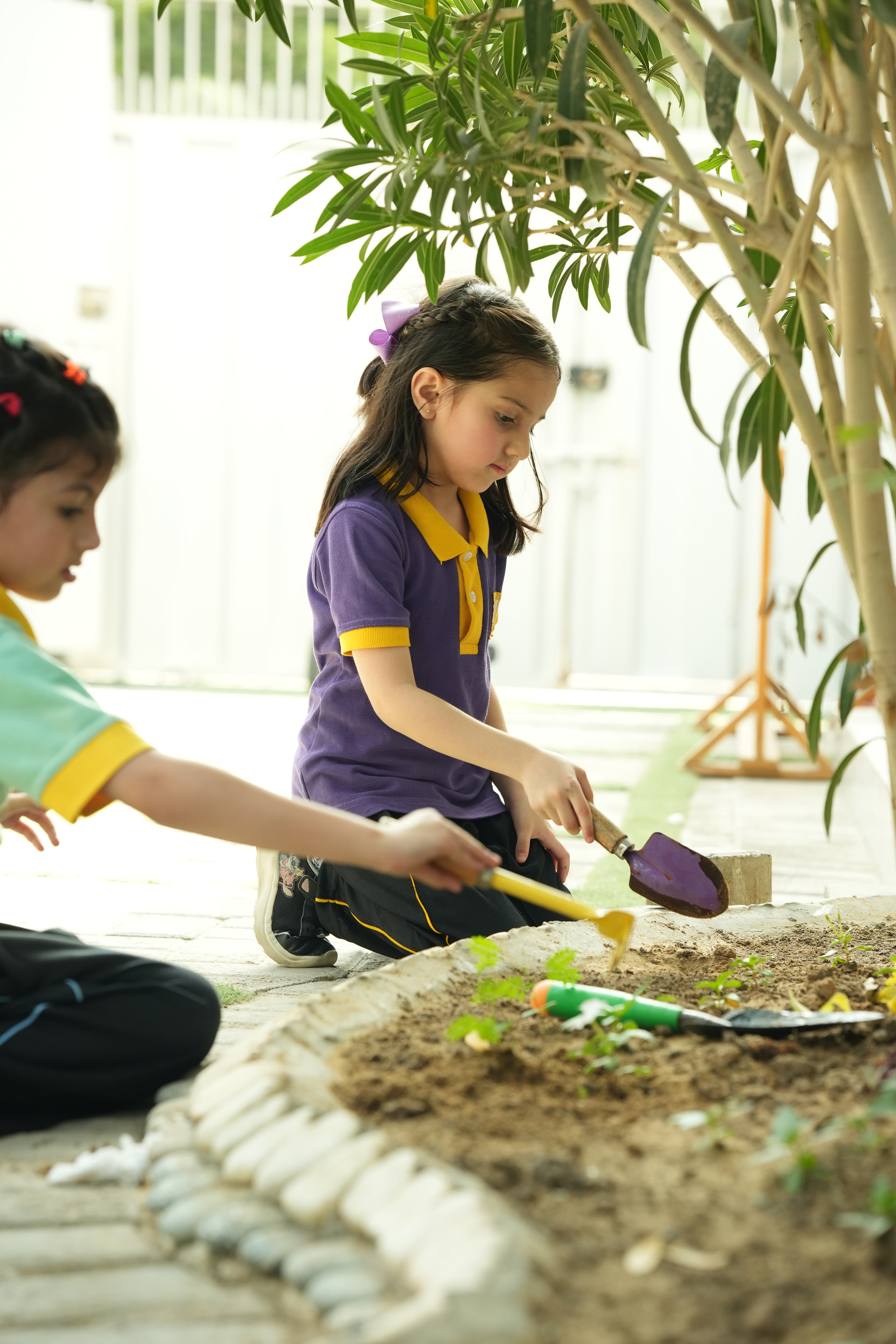 Children gardening together in the outdoor space