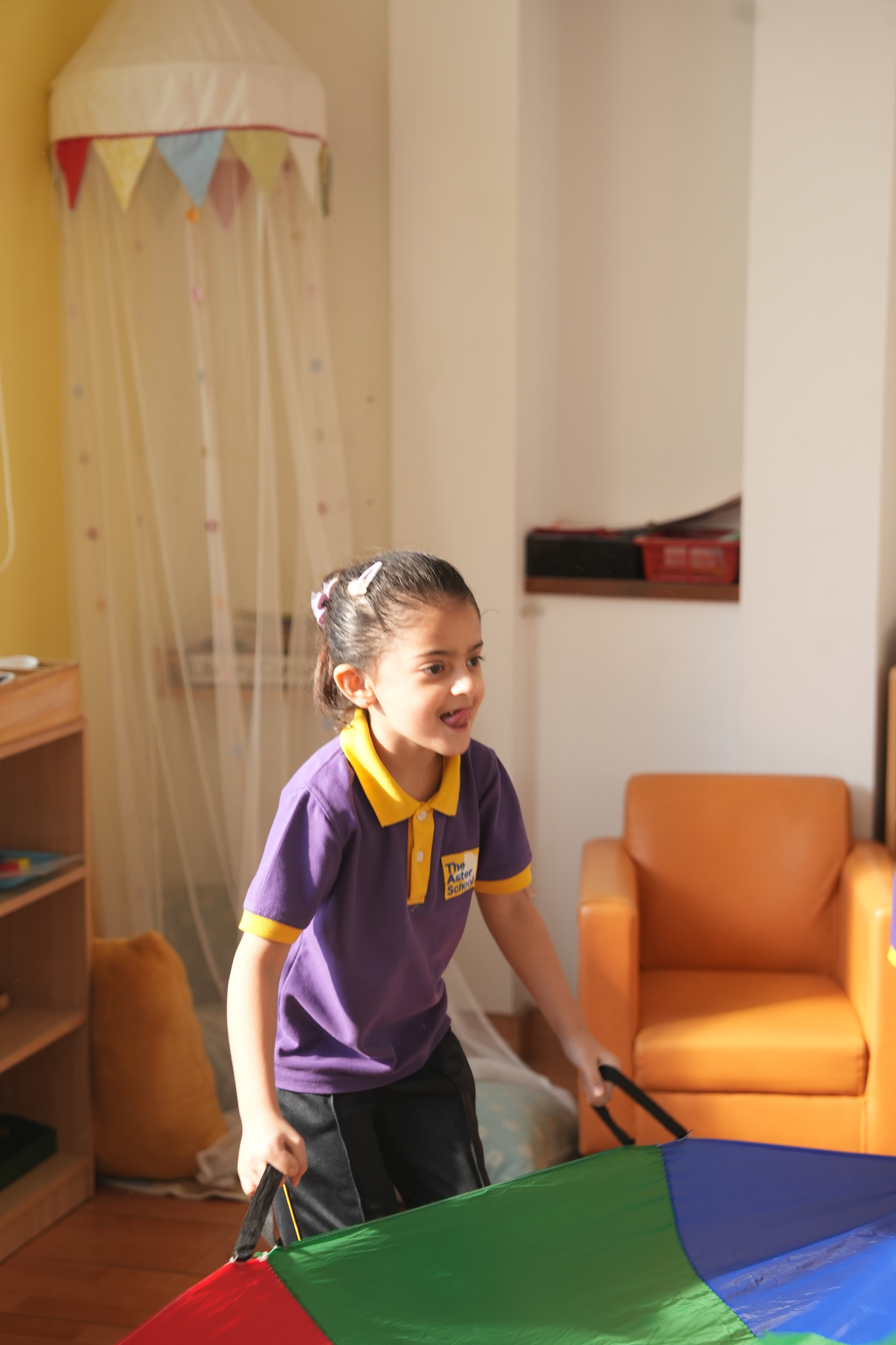 A child playing with a parachute in the cosy corner
