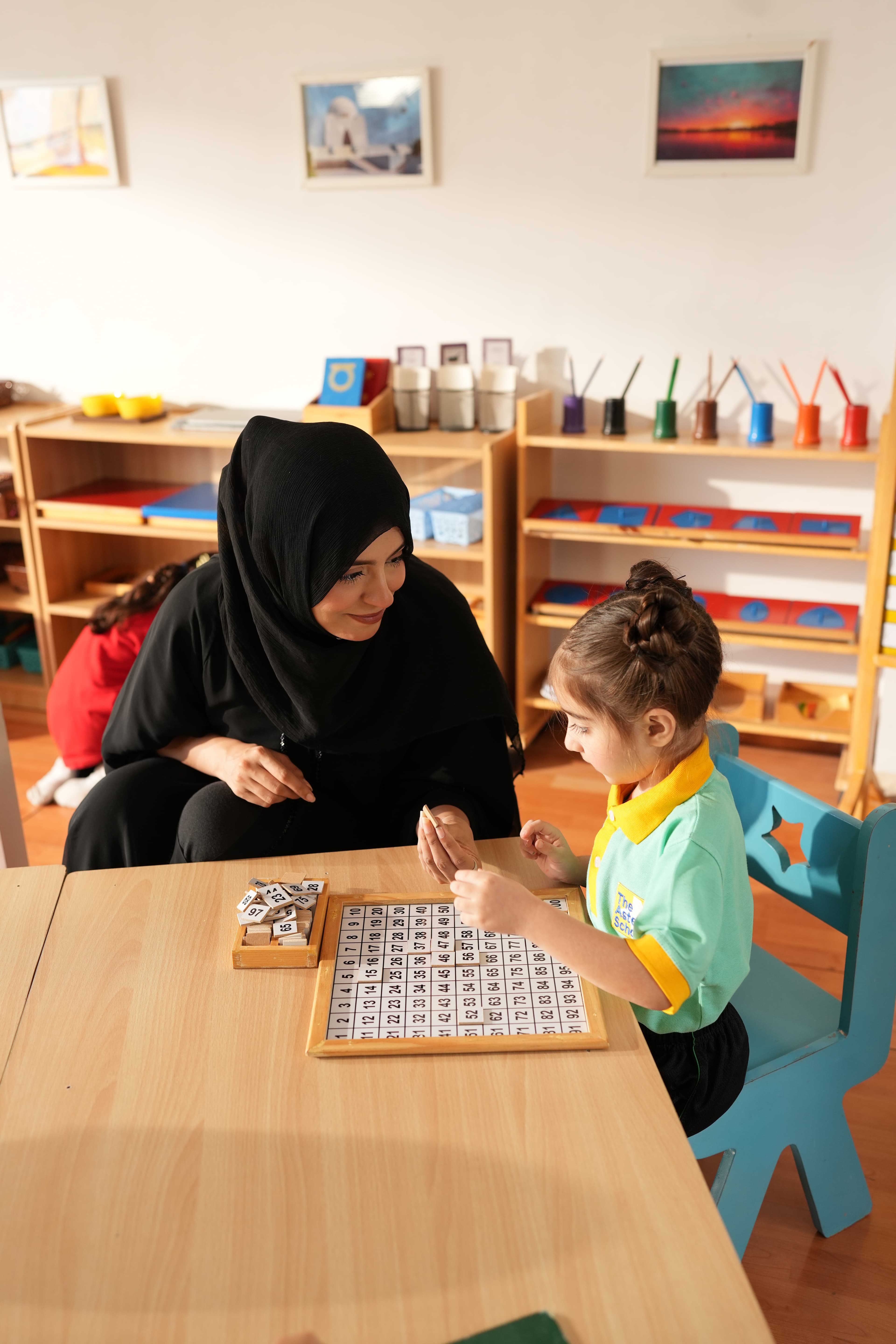 Children at play in a supervised, secure outdoor area at Aster